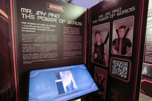 Video display of the Kink Responsibly exhibition during Darklands 2025.
